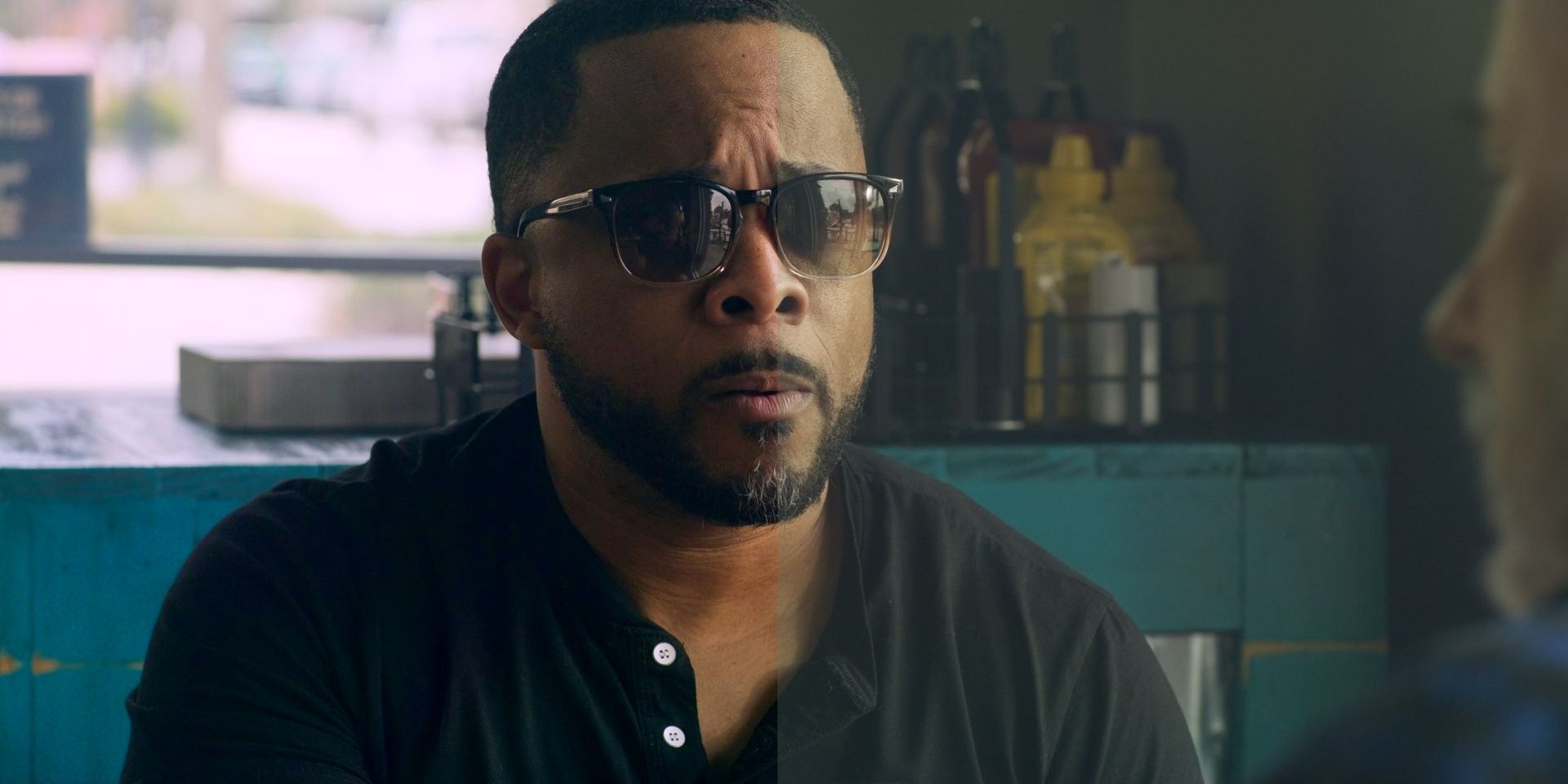 The same frame split down the middle: on the left, the original color grade with deep blacks and rich teal; on the right, the washed-out, flat, gray compressed version most platforms show